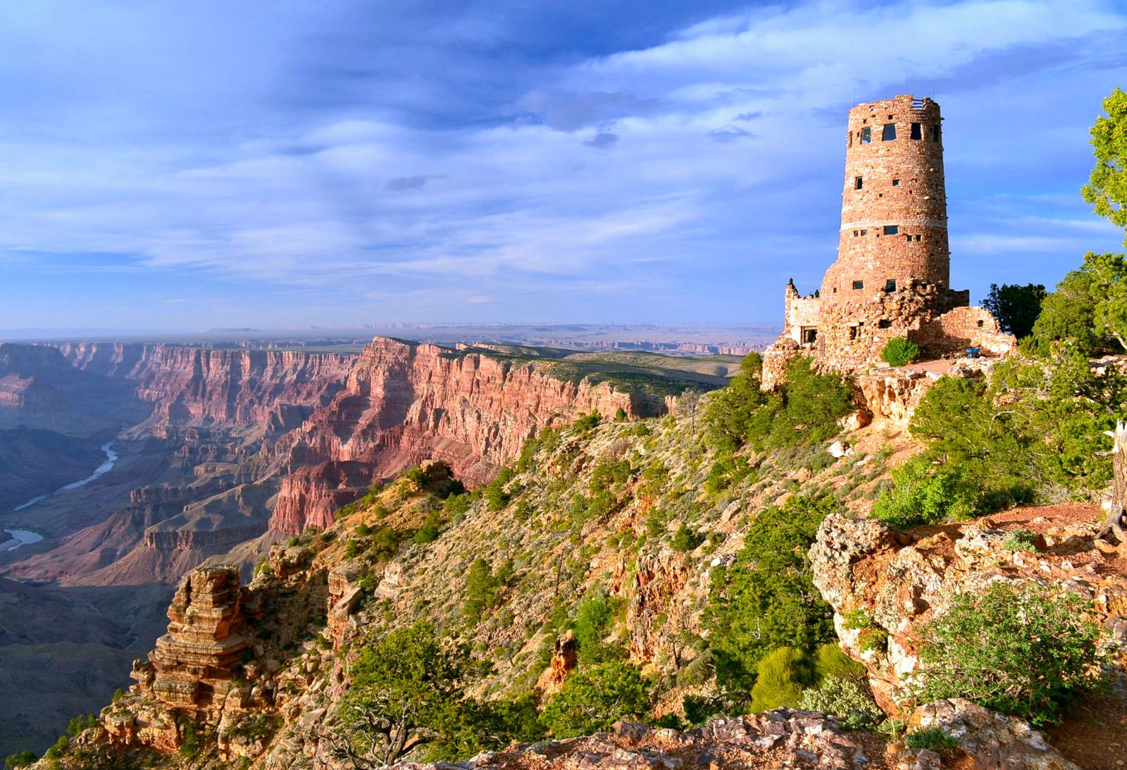 The stone Desert View Watchtower on the rim above the canyon